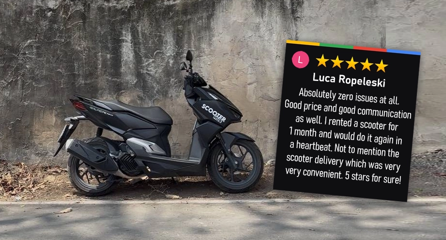 a black honda click 160 scooter hub rental bike parked in front of a wall in the umong area of chiang mai