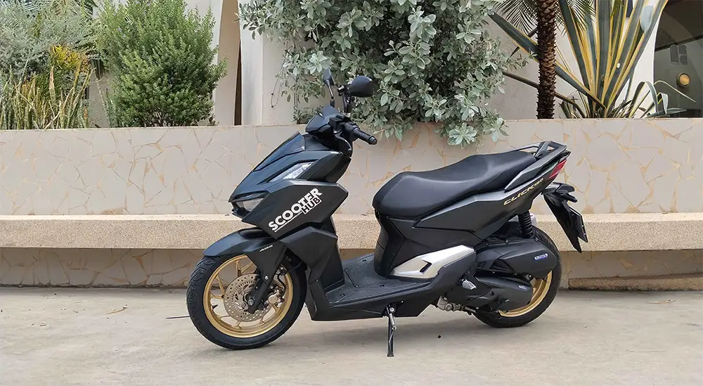 a honda click 160 parked in front of a cafe