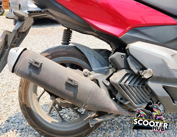a damaged scooter hub bike showing a bike missing an exhaust shield