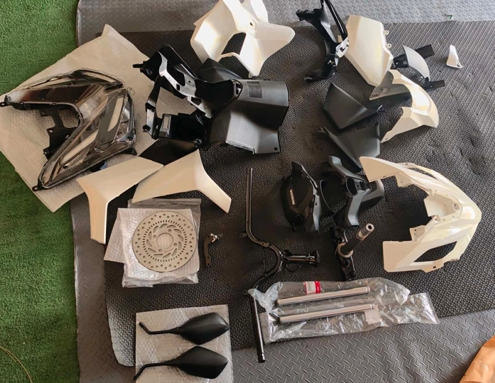 a collection of parts that were used to fix a severely damaged scooter hub bike