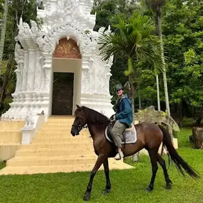 a man riding a horse infront of a temple