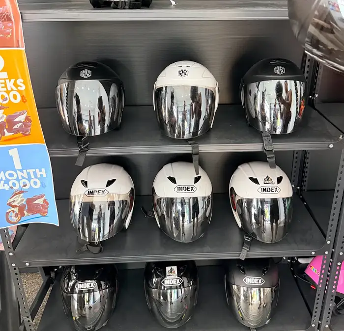 scooter hub helmets on a rack