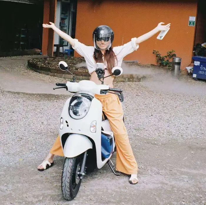a happy customer on a scooter hub scooter