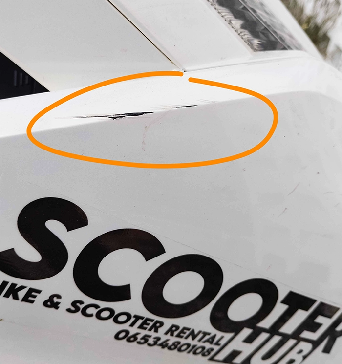 scratches on a scooter hub rental bike to demonstrate that we don't charge for small scratches and nicks