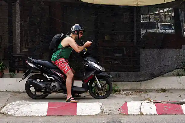 a man on his rental scooter in chiang mai getting ready to tackle the samoeng loop
